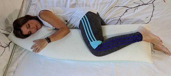 Overhead View Of A Woman In Fitness Clothing Hugging The Standard Body Pillow Eurolux Green Planet Pillow On A Mattress