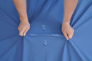 Overhead View Of The Cover Material Wellell Sedens 500 Seat Cushion With Battery Power Shown With A Healthcare Worker Stretching The Cover Highlighting Its Four Way Stretch Capability