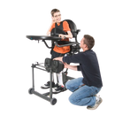 Person Adjusting The EasyStand Evolv Medium With A Child Sitting On It
