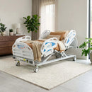 Prius Ai1 Premium All-in-One MedSurge Expandable Low Bed In A Home Setting With A Beige Sofa And Plants 