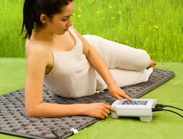 QRS 101 PEMF Home System Mat Woman Laying Down Operating Controls