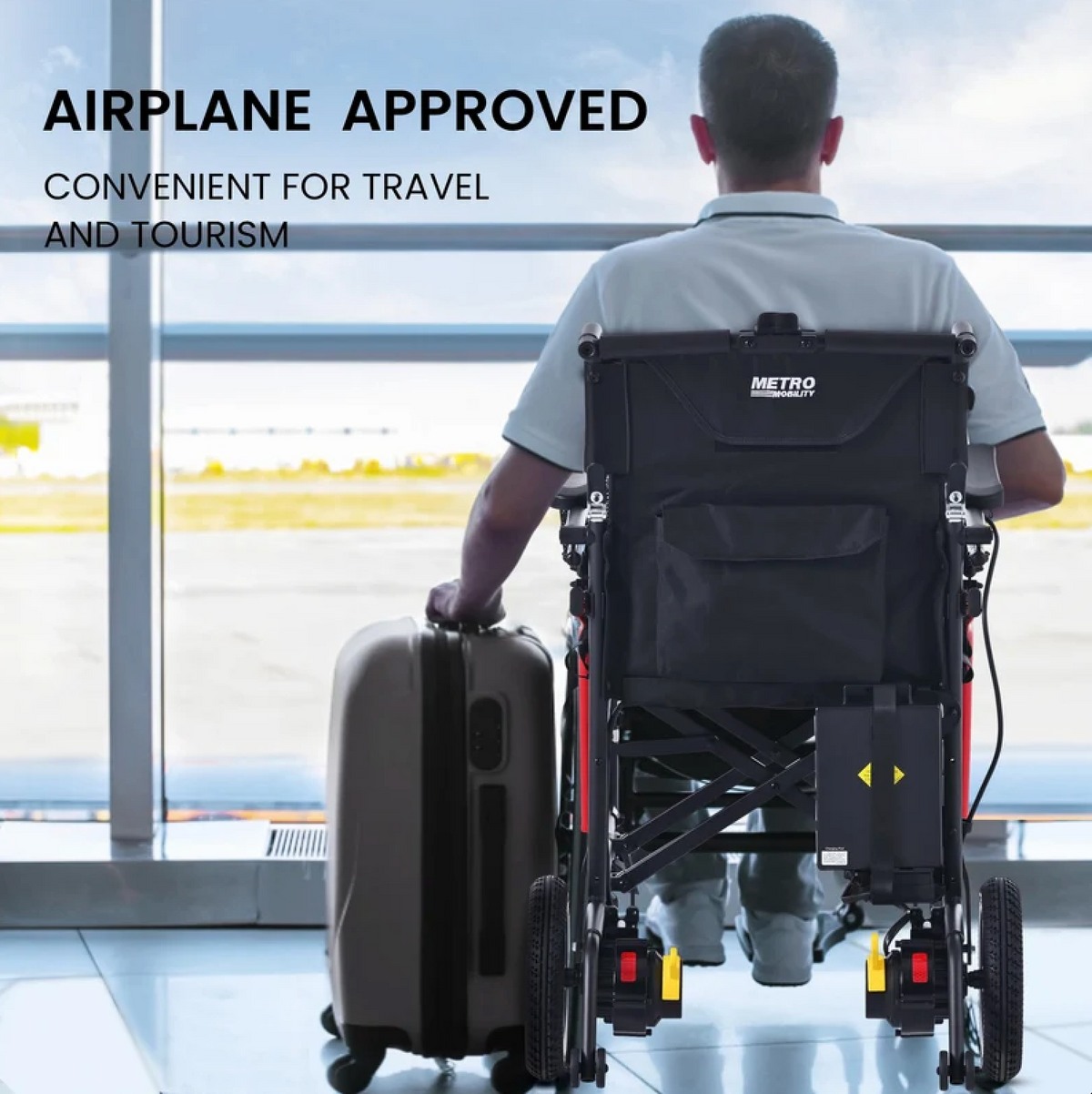 Rear Centered View Of The Metro Mobility iTravel Lite Lightweight Electric Wheelchair Shown With A Man Sitting In The Chair Holding A Suitcase In An Airport Setting With Text Airline Approved And Convenient For Travel And Tourism