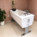 Rear Left Side View Of The TR Equipment Bathtub Comfortline Bath System Shown In The White Cover In An Indoor Bathroom Setting