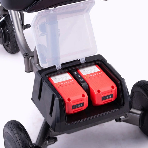 Rear Overhead Close Up View Of The Battery Compartment For The Reyhee Triad Compact Folding Electric Mobility Scooter Shown With The Gun Metal Colored Frame