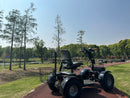 Rear View Of The Green Transporter Cheeta Golf All-Terrain Mobility Scooter Right Side In An Outdoor Park Setting