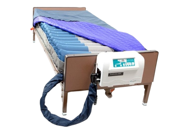 Rear View Of The Proactive Medical Protekt Aire 9900 Low Air Loss/Alternating Mattress System With Cover Removed On A Brown Metal Frame, With The Control Unit Attached To The Footboard