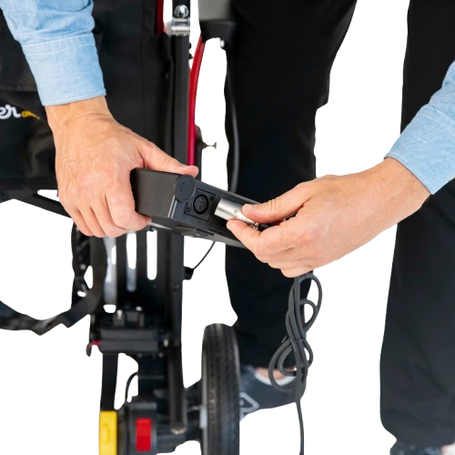 Removeable Battery Attachment Of The Feather Electric Wheelchair With Person Connecting The Charger