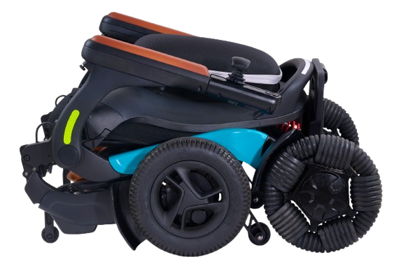 Right Side View Of The Golden Technologies Ally Pro Omnidirectional Electric Wheelchair Shown In Teal Color And In The Folded Position