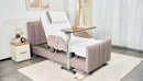 Right Side View Of The StarSleep Arlo Rotating Bed In The Head Elevated Position With Optional Foam Pillow And Overbed Table Shown In A Bedroom Setting