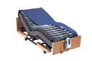 Right Side View Of The Wellell Domus 2 Alternating Pressure Redistribution Mattress Shown On An Adjustable Bed With The Control Unit Hanging Off The Footboard