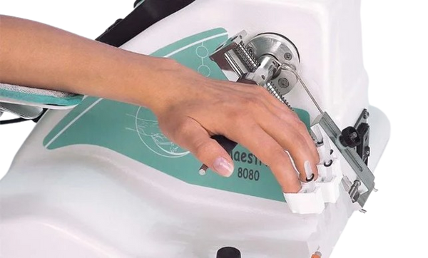 Side View Of A Person Using The Kinetec Maestra Hand And Wrist CPM Machine
