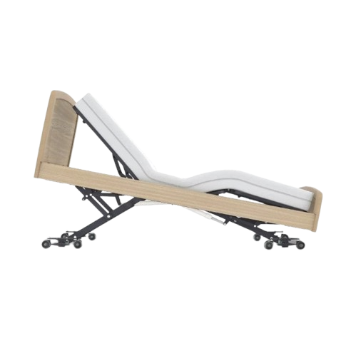Side View Of The Accora Empresa 12-Function Hi-Low Adjusting Nursing Bed Shown In Skandi Design In The Reverse Trendelenburg Position And Oak Wood Finish