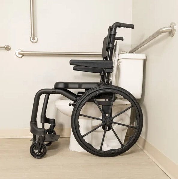 Side View Of The ActiveAid SC Self-Propelled Shower Commode Chair Shown With Black Frame And In A Bathroom Setting