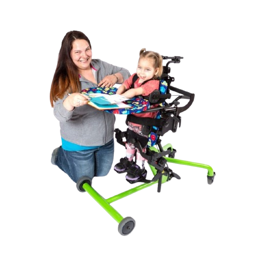 Side View Of The EasyStand Bantam Extra Small Standing Frame Shown In Green Color With Child Using The Device With A Woman Kneeling Next To Her
