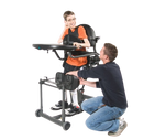 Side View Of The EasyStand Evolv Large Shown With Young Adult Using The Stander With Middle Aged Man Kneeling Next To Him