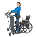 Side View Of The EasyStand StrapStand Standing Frame Shown With Woman Using The StrapStand From A Wheelchair