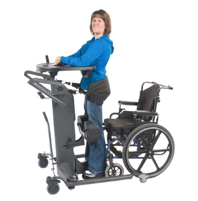 Side View Of The EasyStand StrapStand Standing Frame Shown With Woman Using The StrapStand From A Wheelchair