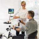 Side View Of The Kinetec Kinevia Duo Active Passive Trainer Doctor Explaining The Machine While Patient Operates It