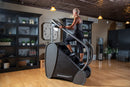 Side View Of The StairMaster Stairway GTL Stair Climber Shown With A Woman Operating The Climber In A Home Setting