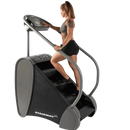 Side View Of The StairMaster Stairway GTL Stair Climber Shown With A Woman Operating The Climber