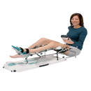 Side View Of Woman Using The Kinetec Spectra Knee CPM Machine With The Remote Control.