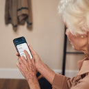 The Dawn House Bed Mobile App Being Used By An Elderly Woman