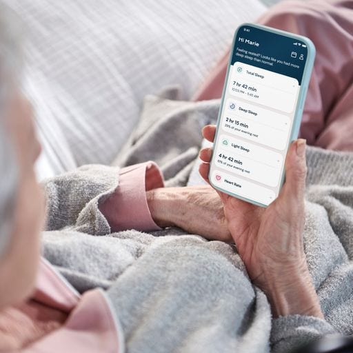 The Dawn House Bed Mobile App Being Used By Elderly Woman