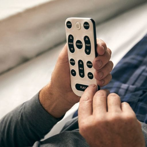 The Dawn House Bed Remote Control Being Used By An Elderly Man