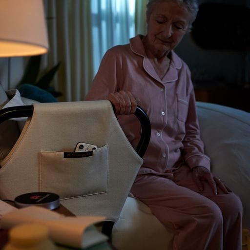 The Dawn  House Bed Side View Of Elderly Woman Holding Onto Side Rail