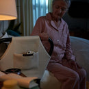 The Dawn  House Bed Side View Of Elderly Woman Holding Onto Side Rail