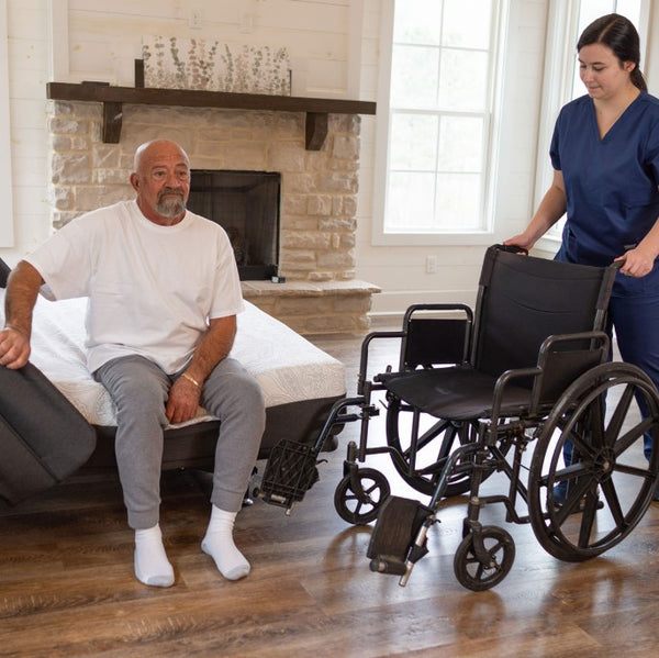 The Flexabed Hi Low Adjustable Bed Side View With Side Rails Wheelchair and Caregiver With Patient
