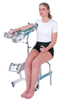 Woman In The Seated Position Front View Using The Kinetec 6080 Elbow CPM Machine