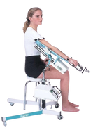 Woman In The Seated Position Side View Using The Kinetec 6080 Elbow CPM Machine