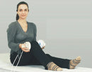 Woman Sitting On A Table With The Almagia International ALMAG-2 PEMF Therapy Device