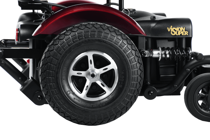 Close Up Right Side View Of The Merits Vision Super Heavy Duty Power Chair In Red Color Wheel