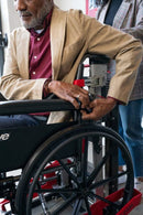 Elderly Man In A Wheelchair Reaching For The Seatbelt On The Atlas Stair Climbing Wheelchair Lift