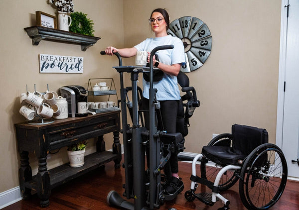 Front View Of The EasyStand Glider Large Active Standing Frame Shown With Woman Using The Device In A Home Setting