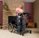 Front View Of The EasyStand StrapStand Standing Frame With Man Using The StrapStand In A Home Setting