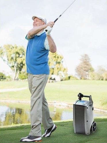 Front View Of The O2 Concepts Oxlife Independence Oxygen Concentrator Shown In An Outdoor Setting With Man Golfing