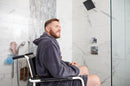 Side View Of The ActiveAid 600 Shower Commode Chair Shown With A Man Sitting In The Chair In A Bathroom Setting