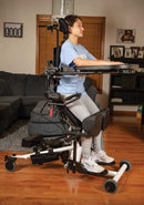 Side View Of The EasyStand Bantam Medium Standing Frame Shown With A Girl Using The Device In A Home Setting