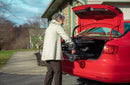 Woman Placing The Feather Wheelchair Into The Trunk Of Her Car In An Outside Setting